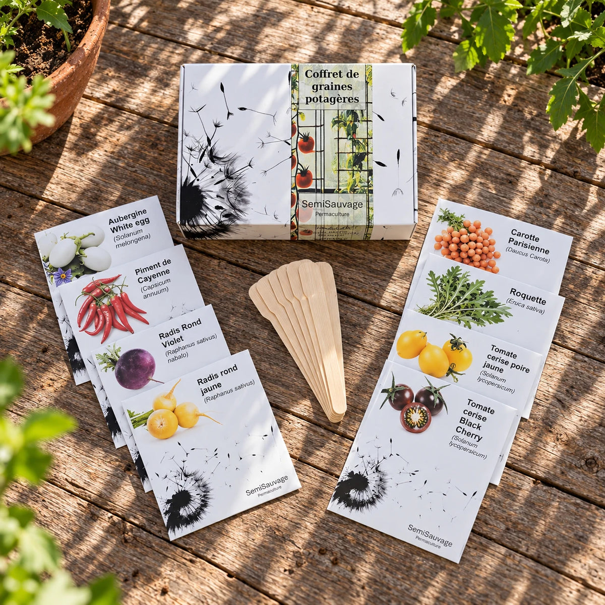 Coffret de graines potagères, huit sachets et étiquettes en bois disposés sur une table.
